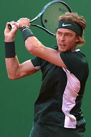 a man holding a tennis racket a man holding a tennis racket